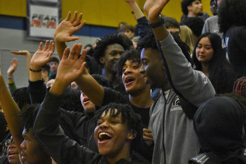 The Battle Spartans' student section waves bye to the Father Tolton basketball team after the Spartans' 63-51 win over the Trailblazers on January 18, 2023, at Battle High School.