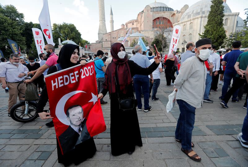 People gather in front of the Hagia Sophia or Ayasofya, after a court decision that paves the way for it to be converted from a museum back into a mosque, in Istanbul