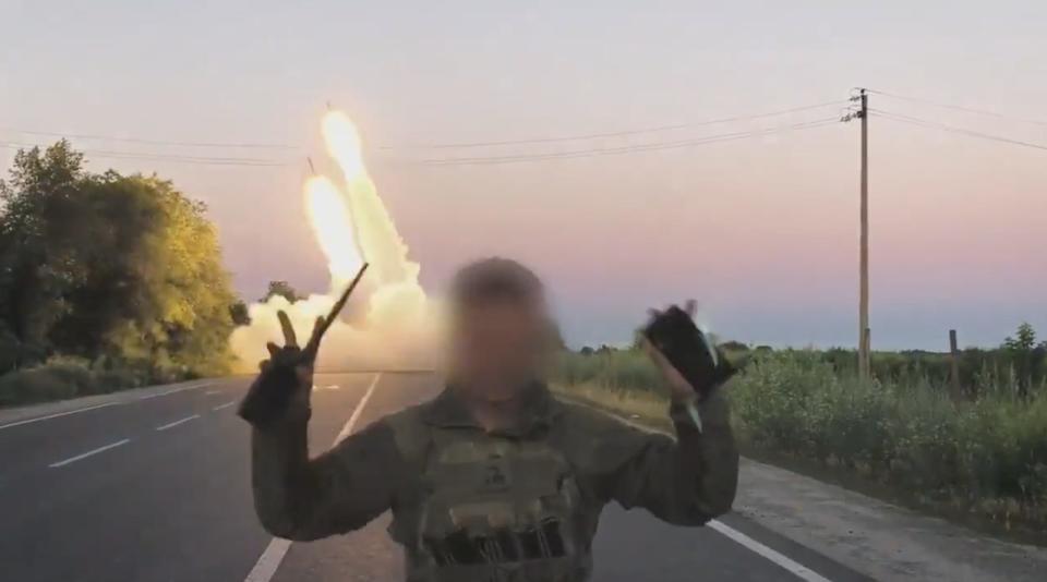 A still from footage shared by the Ukrainian Defense Ministry shows a soldier, whose face is obscured, raise his hands in a 