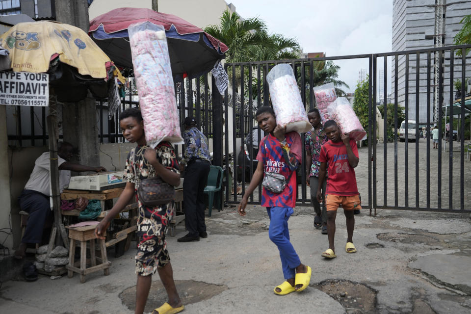 People sells snacks on the streets of Lagos, Nigeria, Tuesday Sept. 5, 2023. (AP Photo/Sunday Alamba)