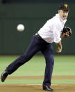 U.S. actor Tom Hanks, wearing a baseball cap of the Yomiuri Giants, throws the first pitch before the start of Japan's professional baseball game between the Giants and the Chunichi Dragons at Tokyo Dome in Tokyo, Japan, Friday, May 8, 2009. Keen baseball fan Hanks is in Tokyo to promote his latest film "Angels & Demons" which will be shown around the world on May 15. (AP Photo/Koji Sasahara)