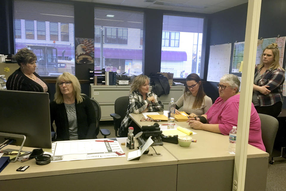 In this Tuesday, Feb. 12, 2019 photo, courthouse staff in York, Neb., prepare to count the ballots cast in the recall election of Mayor Orval Stahr. Stahr was ousted Tuesday in a recall campaign that accused him of violating the trust of city department heads and neglecting the city's interests. Nebraska ranks sixth nationally in the number of recall elections held over the last decade, adjusting for the state's small population. Under a bill proposed by Neb. State Sen. Curt Friesen voters will lose the power to boot Nebraska mayors, county commissioners or school board members out of office before their terms end. Friesen says frequent recall elections in Nebraska could discourage good candidates from seeking public office. (Melanie Wilkinson/The York News-Times via AP)