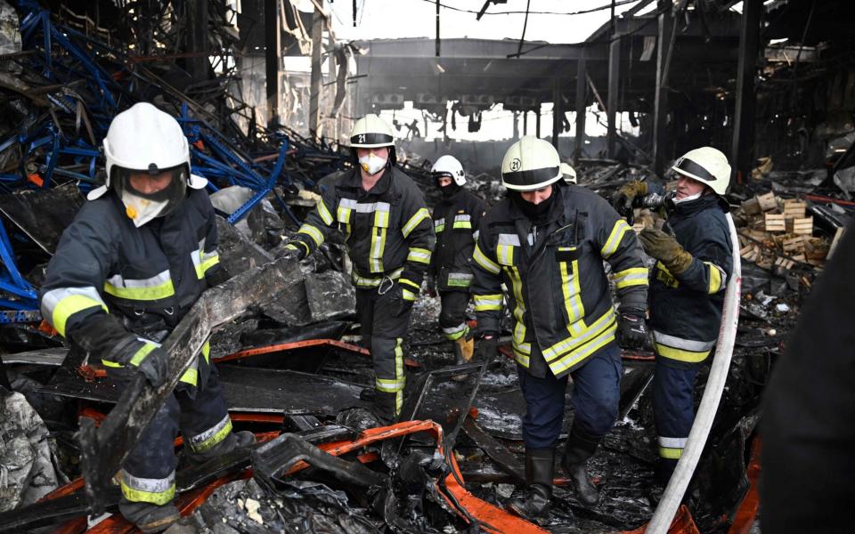 Rescuers on Tuesday continued to clear a warehouse containing more than 50,000 tons of deep-frozen food in the town of Brovary, north of Ukrainian capital of Kyiv, after being destroyed by a Russian rocket strike and shelling - GENYA SAVILOV/AFP