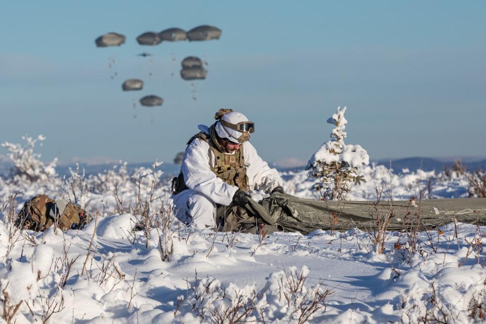 U.S. Army Soldier Pfc. David Hanson, from 3rd Battalion, 509th Parachute Infantry Regiment, 2nd Infantry Brigade Combat Team (Airborne), 11th Airborne Division, recovers his parachute after jumping onto Donnelly Drop Zone as part of Joint Pacific Multinational Readiness Center 24-02 at Donnelly Training Area, Alaska, Feb 8, 2024.