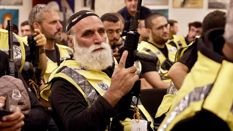 A civilian security squad member holds a rifle at an event attended by Israeli National Security Minister Itamar Ben-Gvir. - William Bonnett/CNN