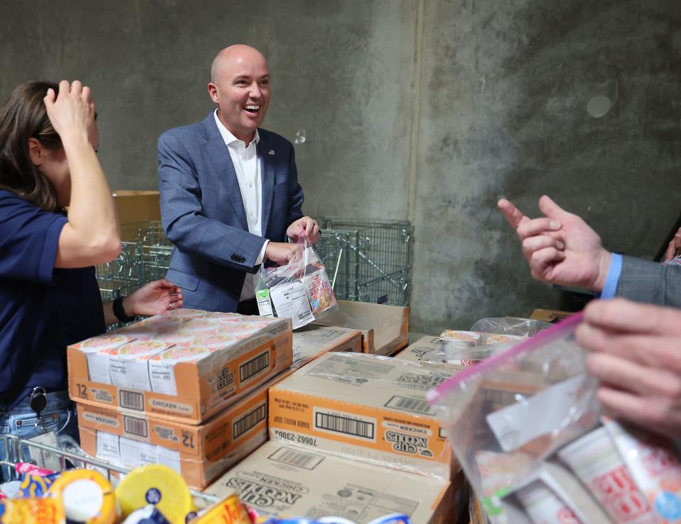 Gov. Spencer Cox puts together weekend food supplies for school children after announcing new service initiatives at the Granite School District offices in West Valley City on Tuesday, Oct. 17, 2023. | Jeffrey D. Allred, Deseret News