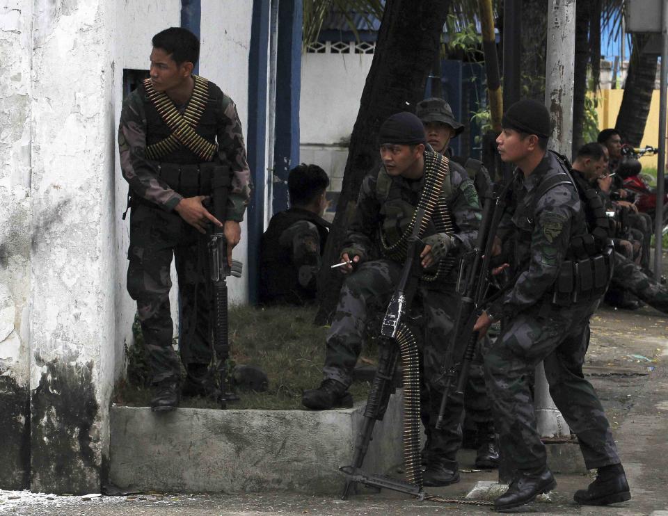 Combat police forces take positions at a village in Zamboanga City in southern Philippines September 9, 2013, where security forces and members of the Moro National Liberation Front (MNLF) rebels were fighting. Rebels took 30 civilian hostages in the southern Philippines on Monday and held security forces in a standoff as part of a drive to derail peace talks, officials said. Police commandos cordoned off parts of Zamboanga City on the island of Mindanao after a rogue faction of the Moro National Liberation Front (MNLF) took hostages and tried to march to the city hall to raise their flag, an army commander said. REUTERS/Stringer (PHILIPPINES - Tags: POLITICS MILITARY CIVIL UNREST)