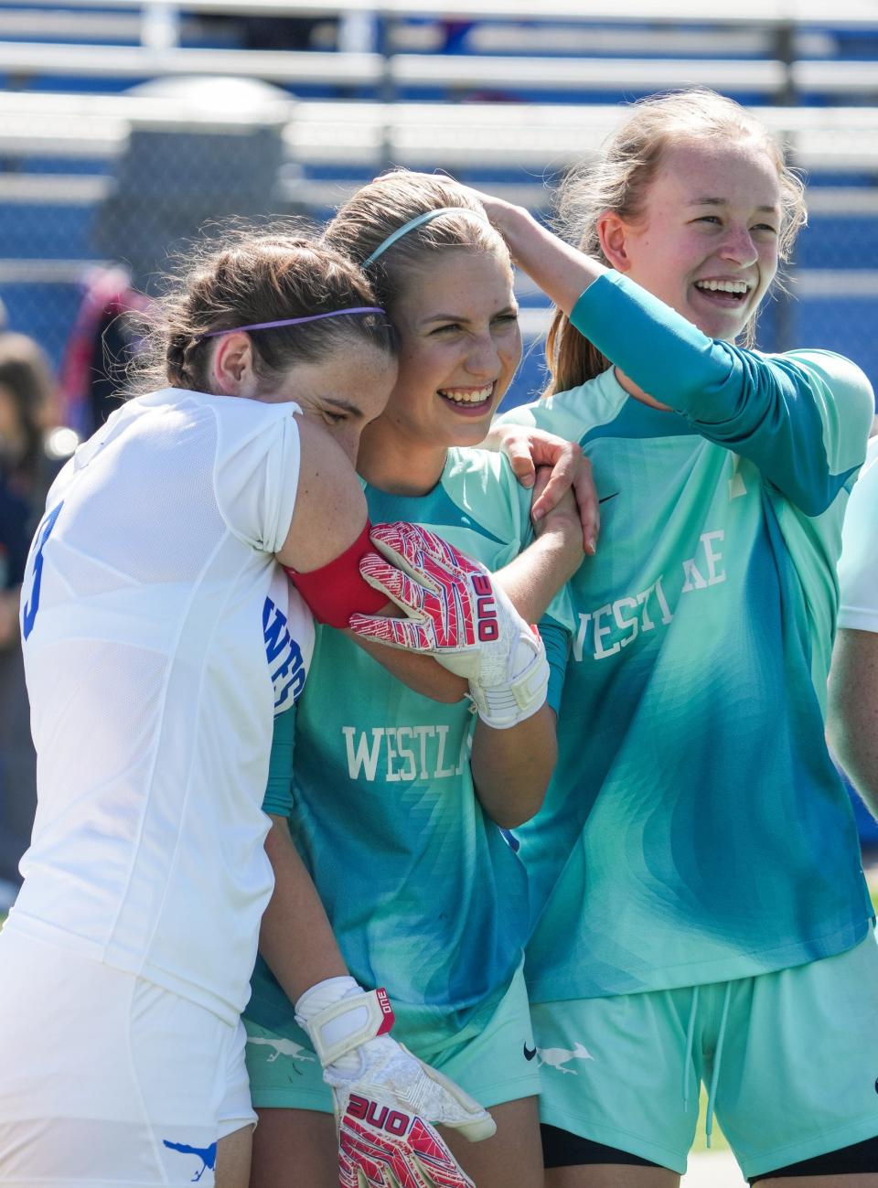 Westlake's Kate Grannis, Sophia Martin and Hannah Hollenbeck celebrate the Chaps' 1-0 victory over Rockwall in a Class 6A state semifinal at Georgetown's Birkelbach Field on Friday.