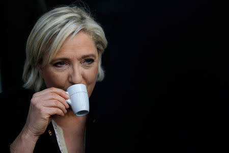 Marine Le Pen, French National Front (FN) political party leader and candidate for French 2017 presidential election, drinks a coffee after a visit to a market in Concarneau, France, March 31, 2017. REUTERS/Stephane Mahe