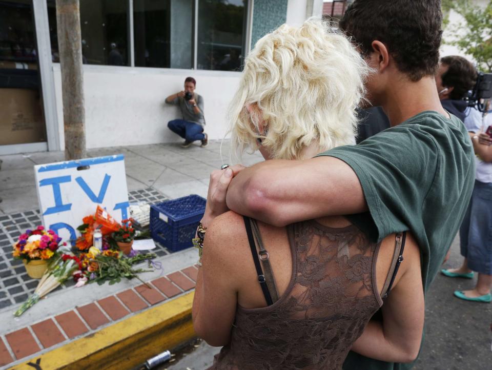UC Santa Barbara students embrace at a makeshift shrine at one of nine crime scenes after series of drive-by shootings that left 7 people dead in the Isla Vista section of Santa Barbara