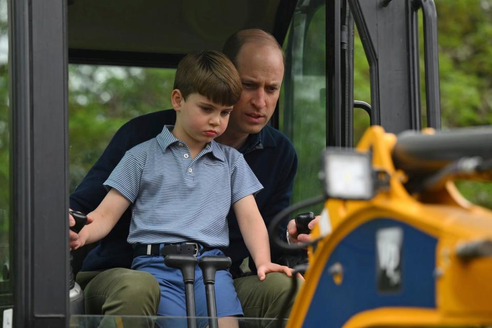 Prince Louis does a bit of digging with supervision from the Prince of Wales (AP)