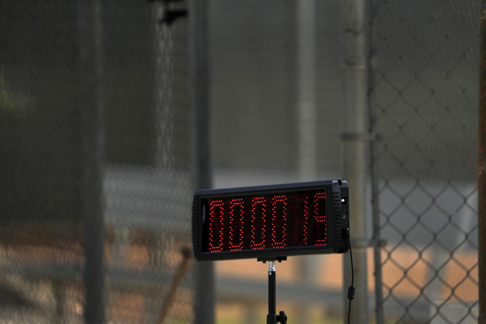 A pitch clock is seen off to the side as the Miami Marlins prepare for live batting practice during spring training baseball practice Sunday, Feb. 19, 2023, in Jupiter, Fla. (AP Photo/Jeff Roberson)