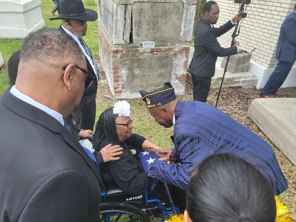 Earl Vanburen, 63, friend of the late Sylvester Jackson, gives his condolences to Jackson's wife Delores, March 9, at the Thibodaux Allen Chapel Cemetery.