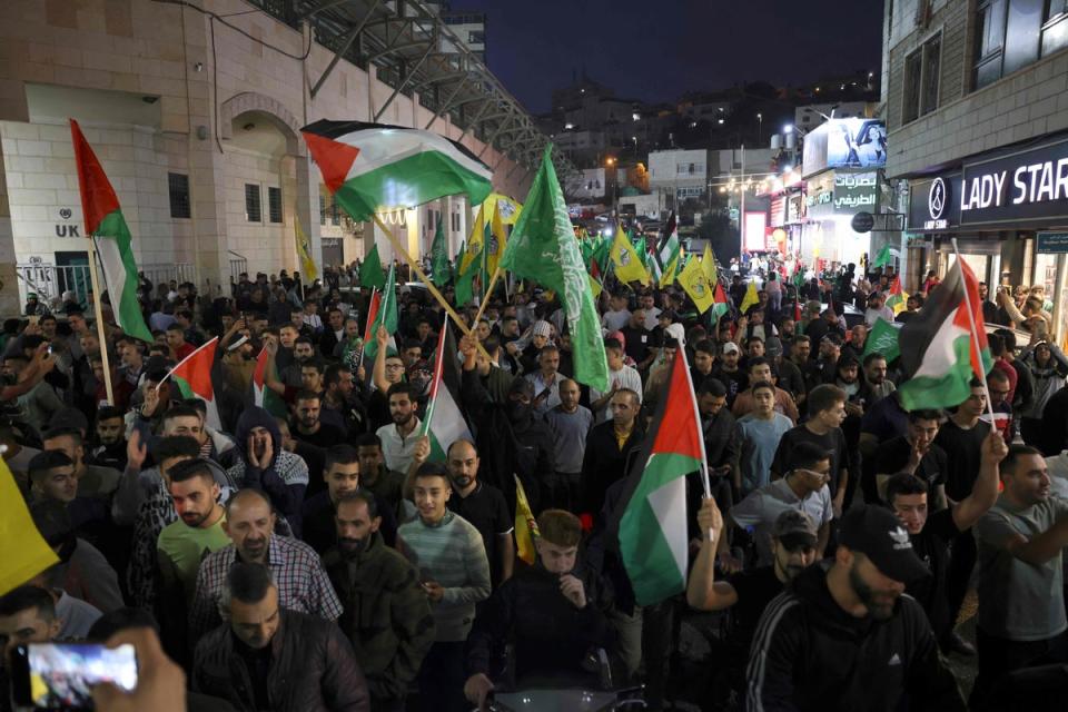 Supporters of the Fatah and Hamas movments march in Hebron city in the occupied West Bank (AFP via Getty Images)