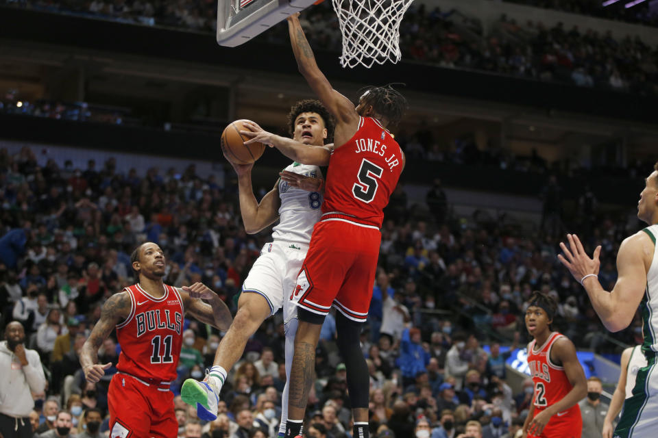 Dallas Mavericks guard Josh Green (8) drives to the basket against Chicago Bulls forward Derrick Jones Jr. (5) in the second half of an NBA basketball game in Dallas, Sunday, Jan. 9, 2022. (AP Photo/Tim Heitman)