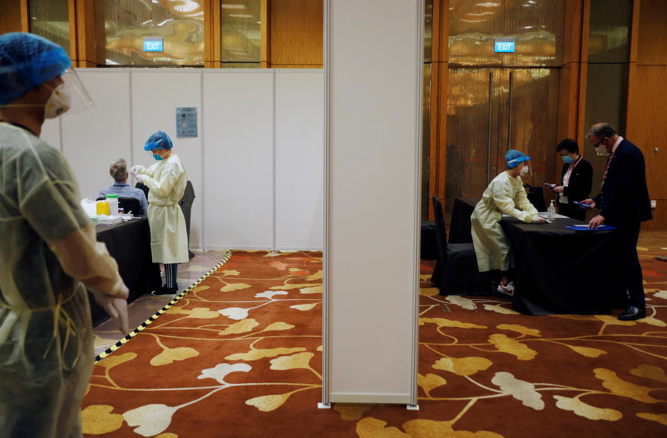 Attendees arrive to take a COVID-19 antigen rapid test before a conference held at Marina Bay Sands Convention Centre in Singapore. 
