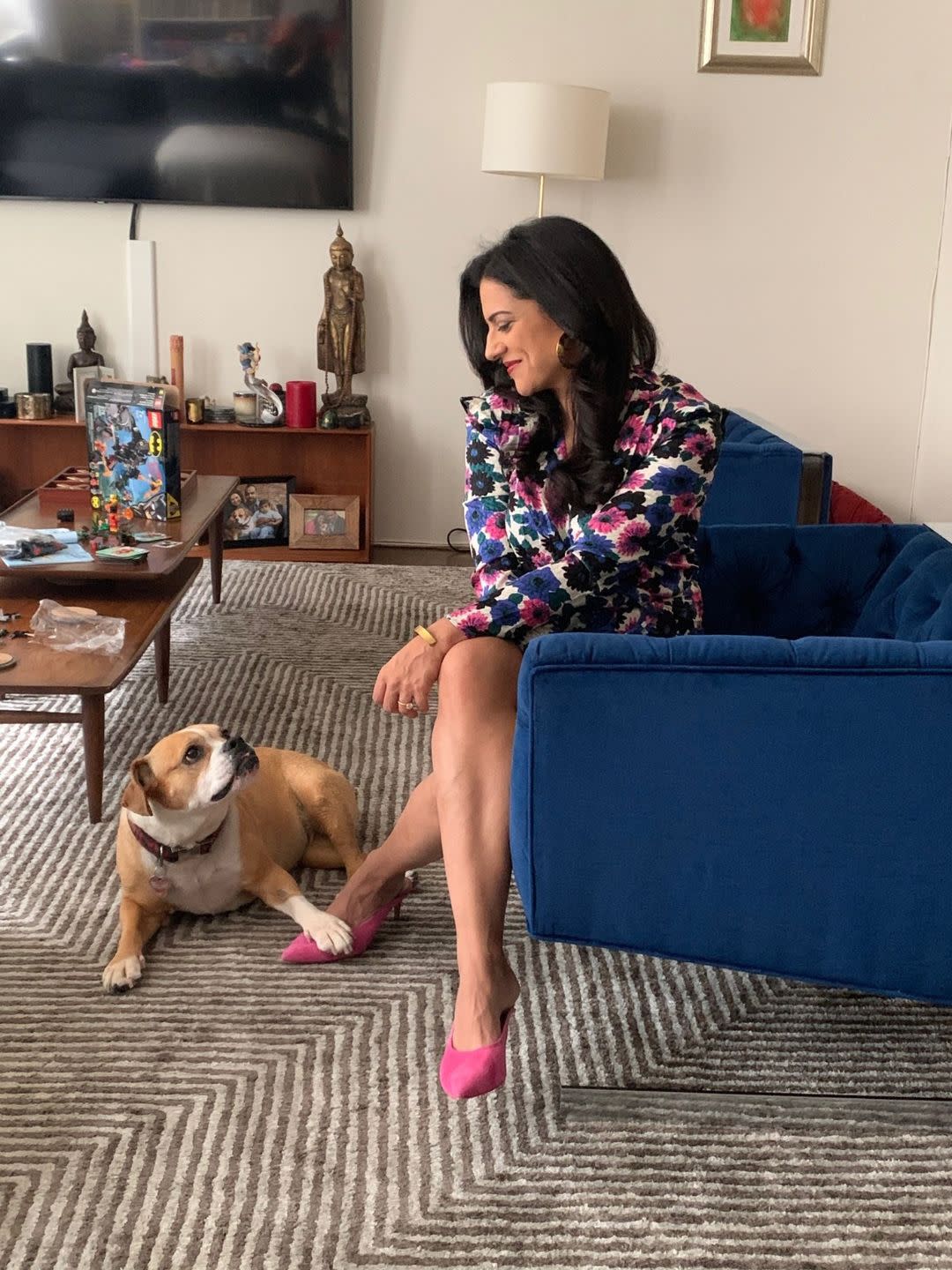 a woman sitting on a couch with a dog