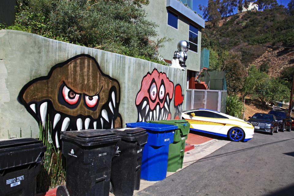 This Sunday May 12,2013 photo shows a mural painted on the outside of the Grammy-winning musician Chris Brown's neighbors are unhappy with what some are calling frightening art he's chosen to have painted along the curb of his Hollywood Hills home of Chris Brown in Los Angeles. The Grammy-winning musician's neighbors are unhappy with what some are calling frightening art he's chosen to have painted along the curb of his Hollywood Hills home. (AP Photo/Richard Vogel)