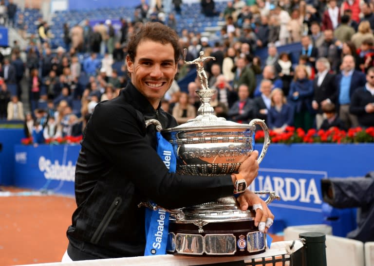 Spanish tennis player Rafael Nadal celebrates with his trophy after winning the ATP Barcelona Open