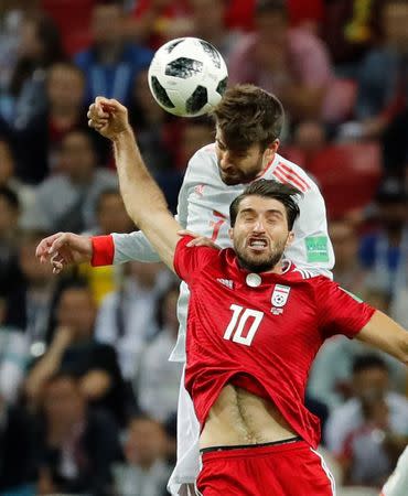 Soccer Football - World Cup - Group B - Iran vs Spain - Kazan Arena, Kazan, Russia - June 20, 2018 Iran's Karim Ansarifard in action with Spain's Gerard Pique REUTERS/Toru Hanai