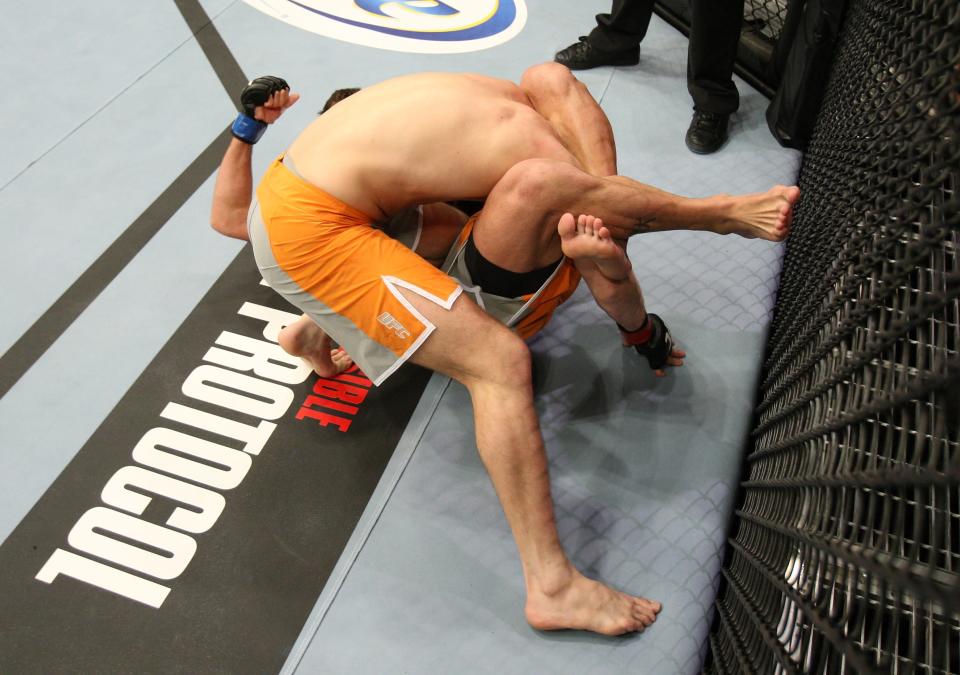 Bryan Caraway (ground) traps Dustin Neace (standing) in a leg choke during The Ultimate Fighter 14 Finale at the Pearl Theatre at the Palms Hotel and Casino on December 3, 2011 in Las Vegas, Nevada. (Photo by Josh Hedges/Zuffa LLC/Zuffa LLC via Getty Images)