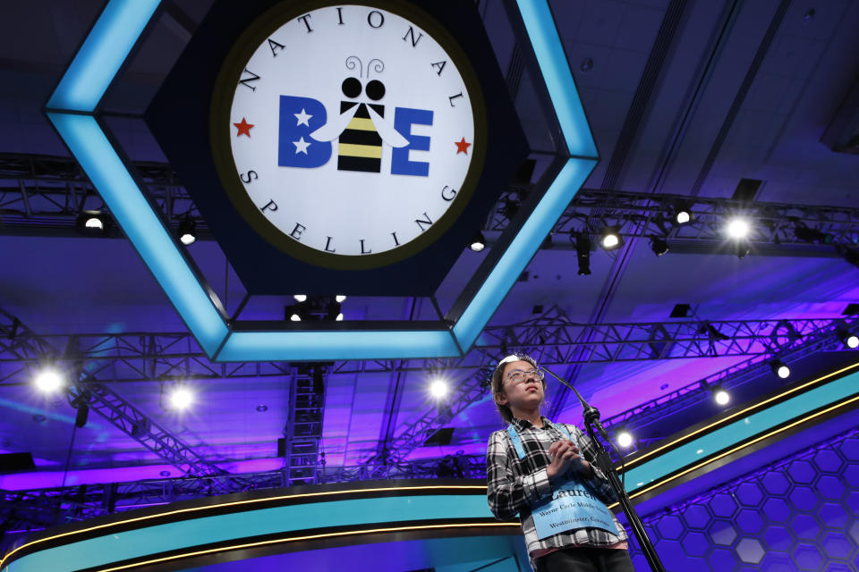 FILE - In this May 31, 2018 file photo, Lauren Guo, 12, from Arvada, Colo., competes in the Scripps National Spelling Bee in Oxon Hill, Md. An unremarkable sound can be the toughest thing for spellers to master at the Scripps National Spelling Bee. It's known as the schwa. It sounds like "Uh," and any vowel can make the sound. Spellers have a variety of techniques to figure out unfamiliar schwas, but none of the strategies is foolproof, and sometimes the only things to do are to memorize the word or guess. (AP Photo/Jacquelyn Martin, File)