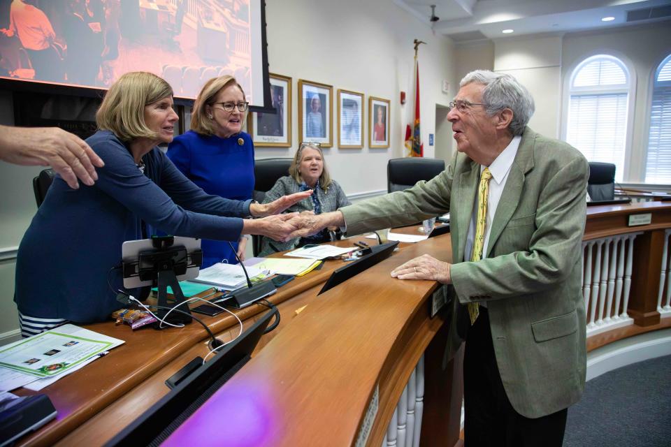 Longtime Town Attorney Skip Randolph (r) who retired last month, receives well-wishes from (l-r) Councilwoman Bobbie Lindsay, Council President Maggie Zeidman and Mayor Danielle Moore during Tuesday's Town Council meeting at Town Hall.