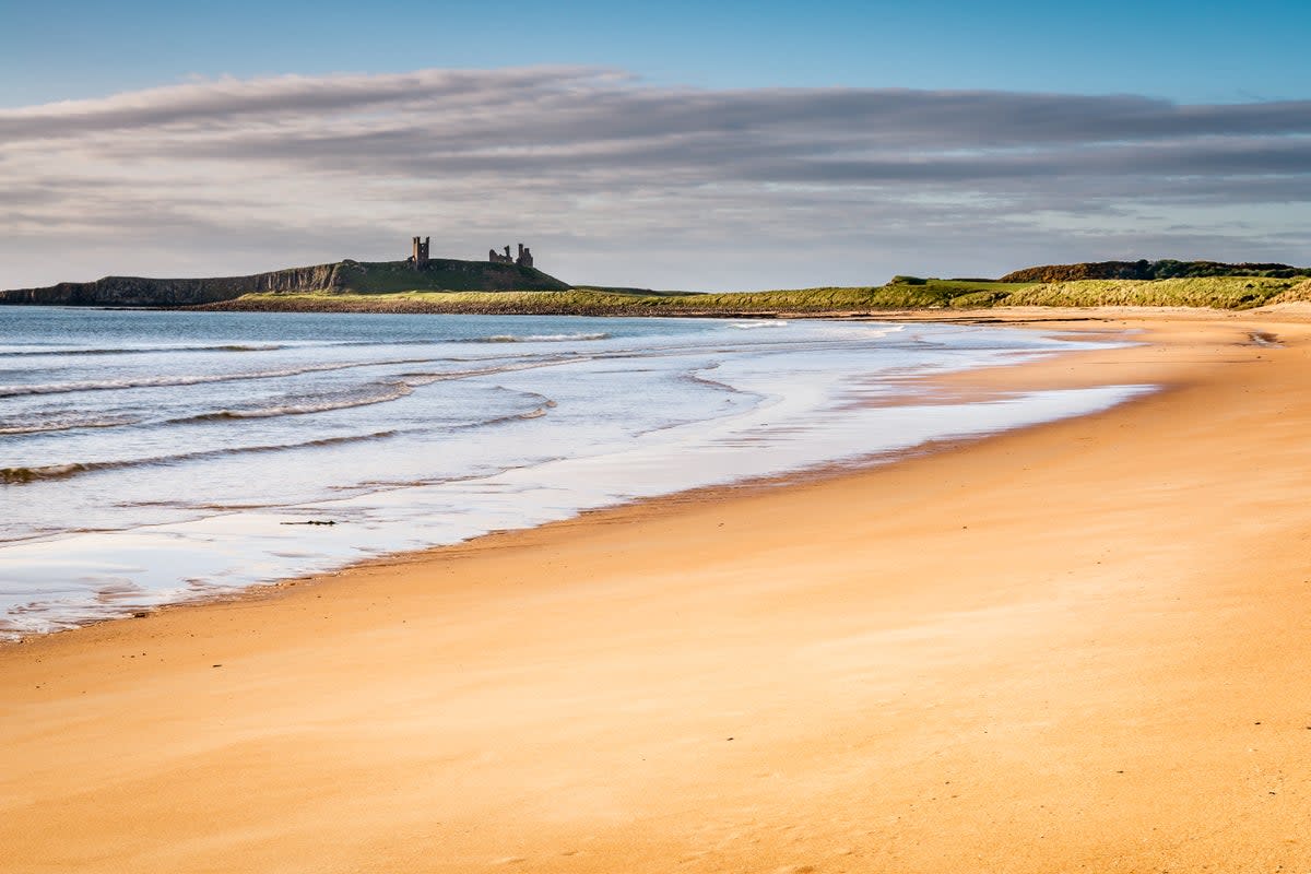 Embleton Bay is overlooked by the ruins of Dunstanburgh Castle (Getty Images/iStockphoto)