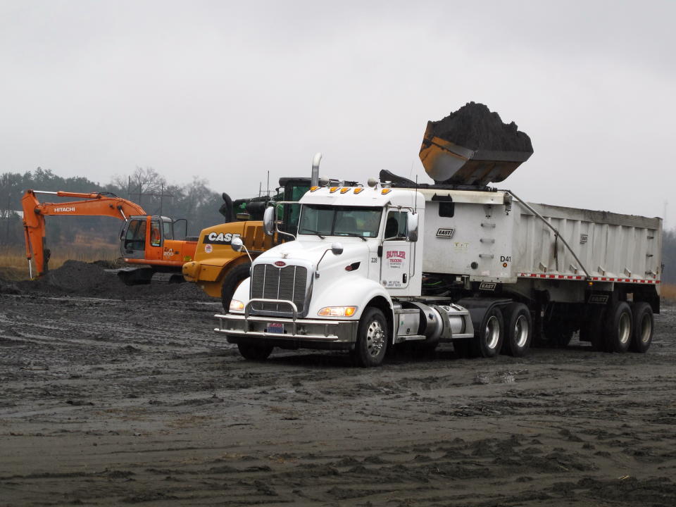 Coal ash is loaded into a truck at at Santee Cooper's Jefferies power generating station just outside Moncks Corner, S.C., on Feb. 26, 2014. The recycled coal ash is trucked from the site and then used in the manufacture of concrete. Santee Cooper is South Carolina's state-owned electric and water utility. (AP Photo/Bruce Smith)