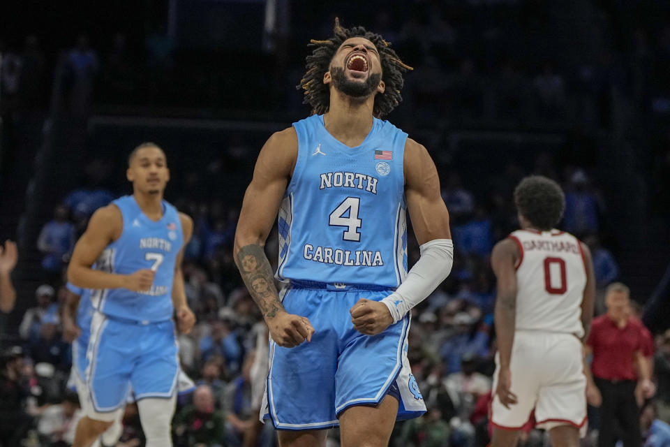 FILE - North Carolina guard RJ Davis celebrates after scoring against Oklahoma during the first half of an NCAA college basketball game Wednesday, Dec. 20, 2023, in Charlotte, N.C. RJ Davis is the unanimous choice as The Associated Press men’s basketball player of the year in the Atlantic Coast Conference, in voting released Tuesday, March 12, 2024. (AP Photo/Chris Carlson, File)