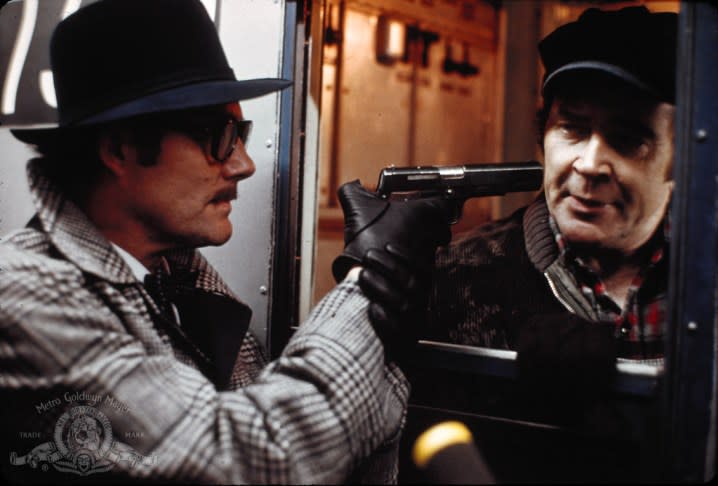 Robert Shaw's "Mr. Blue" threatens a train conductor in The Taking of Pelham 123.