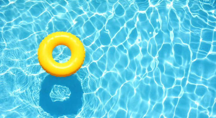 Yellow pool float, ring floating in a refreshing blue swimming pool