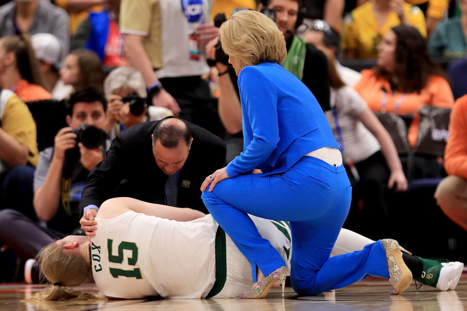 TAMPA, FLORIDA - APRIL 07:  Lauren Cox #15 of the Baylor Lady Bears is tended to by the trainer and head coach Kim Mulkey after sustaining a leg injury during the third quarter in the championship game of the 2019 NCAA Women's Final Four against the Notre Dame Fighting Irish at Amalie Arena on April 07, 2019 in Tampa, Florida. (Photo by Mike Ehrmann/Getty Images)