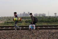 GHAZIABAD, UTTAR PRADESH, INDIA - 2020/05/13: Migrant workers carrying their belongings walk along a railway track returning to their home, during an extended nationwide lockdown to slow the spread of the coronavirus disease. (Photo by Amarjeet Kumar Singh/SOPA Images/LightRocket via Getty Images)