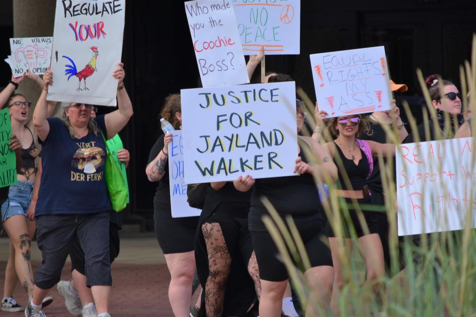 A protester at the Fourth of July Freedom March in downtown Canton carries a sign demanding justice for Jayland Walker, who was killed by police in Akron on June 27.