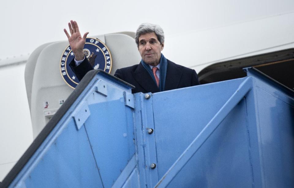 US Secretary of State John Kerry waves while boarding his plane at Franz-Josef-Strauss Airport in Munich, southern Germany, on Sunday Feb. 2, 2014. Kerry was in the Bavarian capital to attend the Munich Security Conference. (AP Photo/Brendan Smialowski,Pool)I