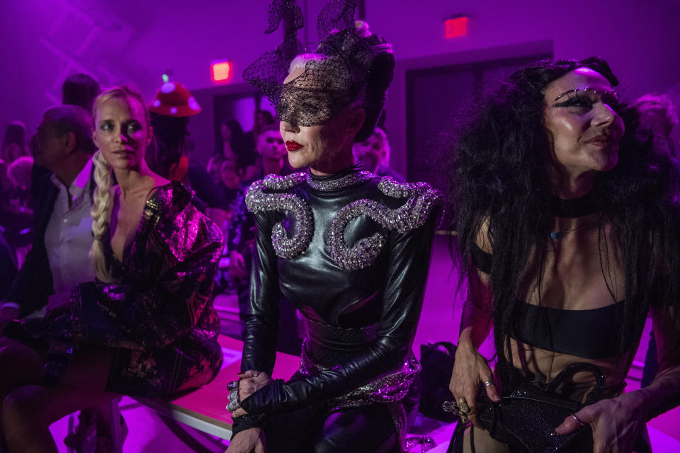 Daphne Guinness, center, and Susanne Bartsch, right, in attendance at The Blonds fashion show at Spring Place on Wednesday, Sept. 14, 2022, in New York. (AP Photo/Brittainy Newman)