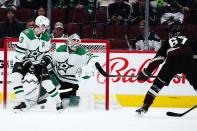 Arizona Coyotes left wing Lawson Crouse (67) scores a goal against Dallas Stars goaltender Jake Oettinger, middle, as Stars defenseman John Klingberg (3) looks on during the second period of an NHL hockey game Sunday, Feb. 20, 2022, in Glendale, Ariz. (AP Photo/Ross D. Franklin)