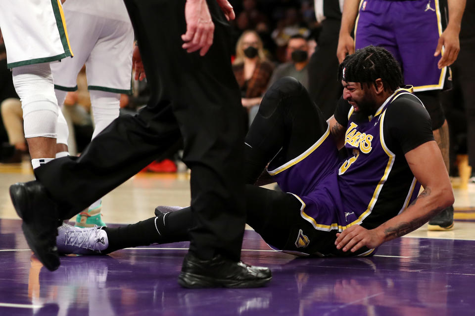 Anthony Davis #3 of the Los Angeles Lakers holds his ankle after an injury during the second quarter against the Utah Jazz at Crypto.com Arena on February 16, 2022 in Los Angeles, California. NOTE TO USER: User expressly acknowledges and agrees that, by downloading and or using this Photograph, user is consenting to the terms and conditions of the Getty Images License Agreement. (Photo by Katelyn Mulcahy/Getty Images)