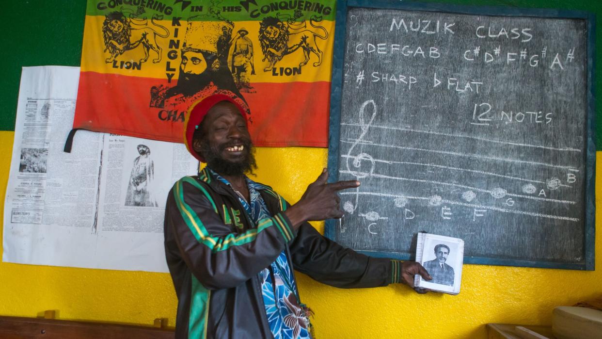  A teacher points to a blackboard in a school in Jamaica. 