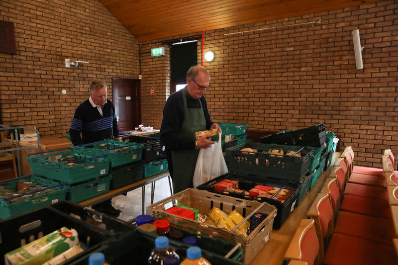 Volunteers package food items to be distributed to benefactors at Leigh baptist church in Leigh