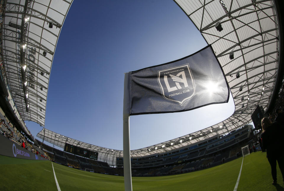 FILE - In this April 29, 2018 file photo taken with a fisheye lens, a flag flies at the Banc of California Stadium prior to an MLS soccer game between Los Angeles FC and the Seattle Sounders in Los Angeles. Los Angeles FC will seek a new name for its 2-year-old Banc of California Stadium after a restructuring of the bank's partnership with the Major League Soccer club. LAFC announced Tuesday, May 26, 2020 that Banc of California will eventually give up its naming rights to the sleek new stadium just south of downtown Los Angeles. (AP Photo/Ringo H.W. Chiu, file)