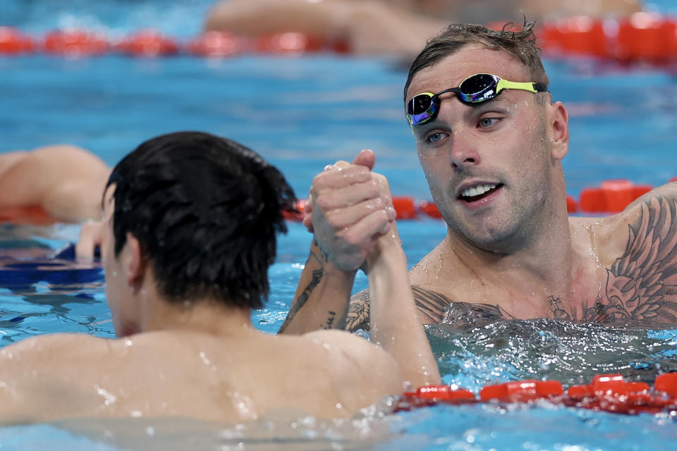 Kyle Chalmers embraces Zhanle Pan at the Olympics.