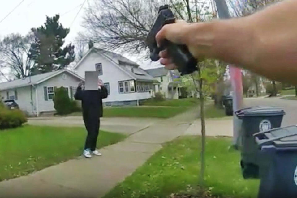 A police officer point his gun at a 15-year-old holding a fake gun on April 1, 2024, in Akron, Ohio. (Akron Police Dept.)