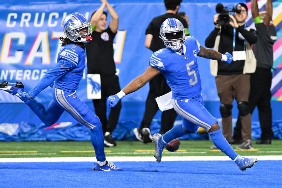 Detroit Lions running back David Montgomery (5) celebrates in the end zone with wide receiver Jameson Williams (9) after running for a touchdown against the Carolina Panthers in the first quarter at Ford Field.