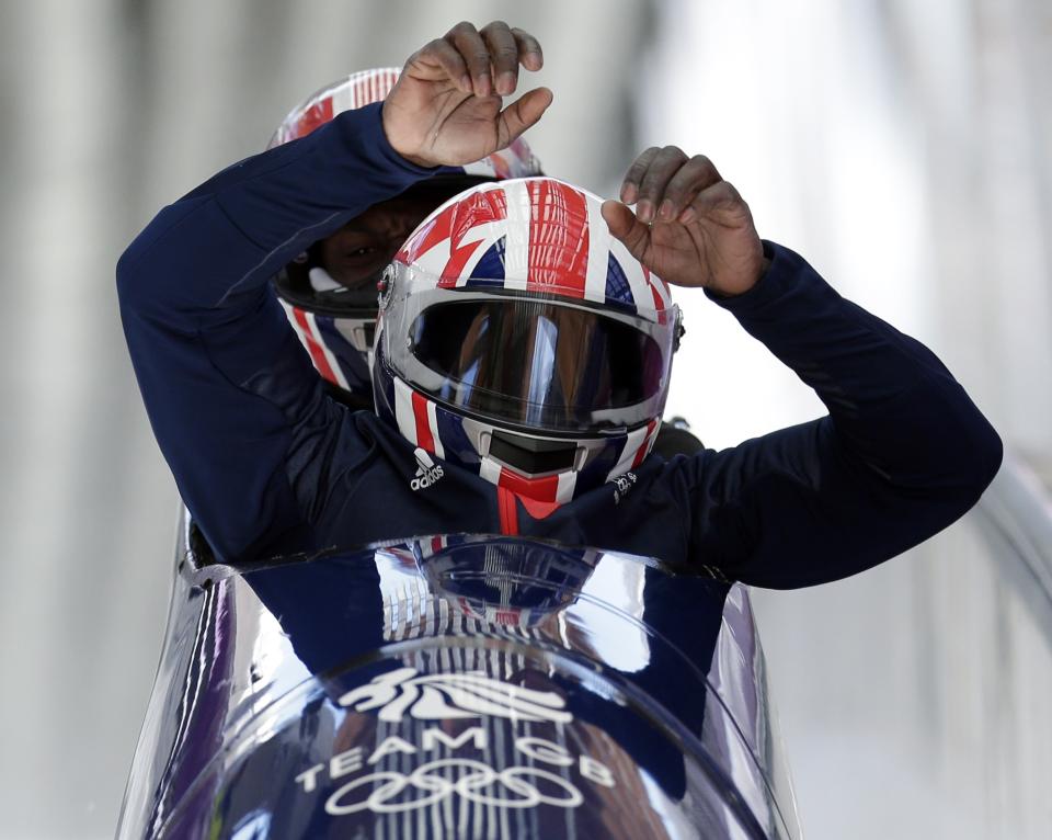 Lamin Deen, the driver for GBR-1 from Great Britain, gets out of his sled in the finish area, after completing a training run in the men's two-man bobsled at the 2014 Winter Olympics, Wednesday, Feb. 5, 2014, in Krasnaya Polyana, Russia. (AP Photo/Michael Sohn)