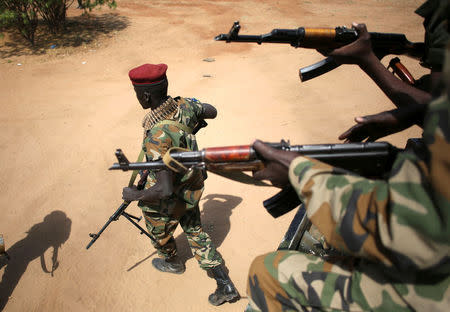 FILE PHOTO - An SPLA soldier walks away from a vehicle in Juba, South Sudan, December 21, 2013. REUTERS/Goran Tomasevic/File Photo