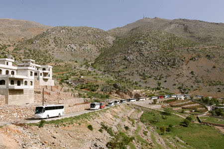 Buses carry Syrian refugees, who fled to Lebanon, back to Syria from the southern village of Shebaa, Lebanon April 18, 2018. REUTERS/Aziz Taher