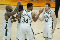 Milwaukee Bucks' P.J. Tucker, from left, celebrates with Khris Middleton, Giannis Antetokounmpo and Pat Connaughton during the second half of Game 5 of basketball's NBA Finals against the Phoenix Suns, Saturday, July 17, 2021, in Phoenix. (AP Photo/Ross D. Franklin)