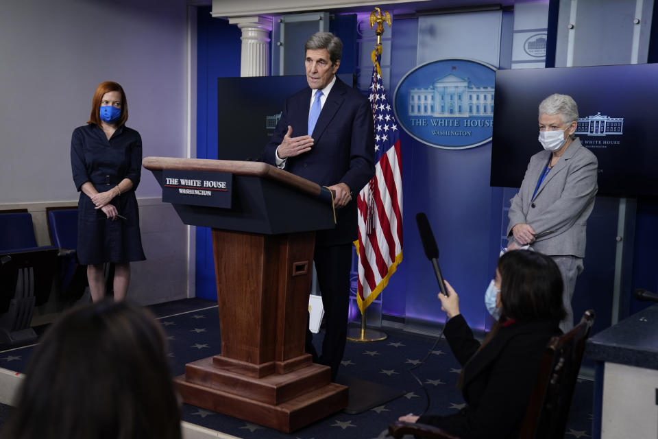 Special Presidential Envoy for Climate John Kerry speaks during a press briefing at the White House, Wednesday, Jan. 27, 2021, in Washington. National Climate Adviser Gina McCarthy, right, and Press Secretary Jen Psaki listen. (AP Photo/Evan Vucci)